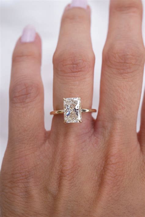 Elongated radiant cut. This gorgeous ring showcases a breathtaking 7 carat VVS-clarity radiant-cut center stone and features a hidden lab-grown diamond halo. 