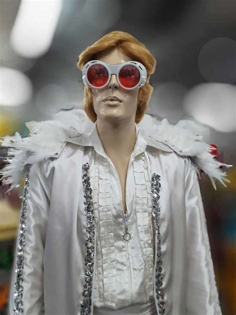 Elton john outift. Aug 23, 2023 · From feathers to sequins and his iconic colorful glasses, John’s clothes captured the attention of the entire world. Elton John’s iconic looks were not only seen onstage, but on red carpets... 