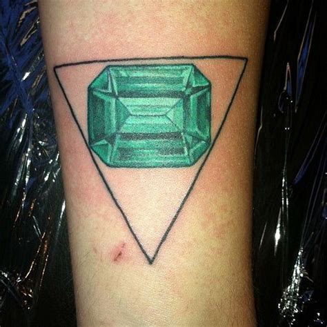 Emerald piercing and tattoo. Phil walked into the lobby of the tattoo shop wearing a beanie hat paired with a tank top showing little peeks into his own rich tattoo history. I searched different... Edit Your P... 