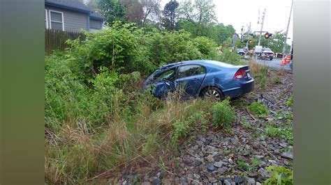 Empty Commuter Rail train strikes car in Beverly after driver passes signage, gets car stuck on tracks