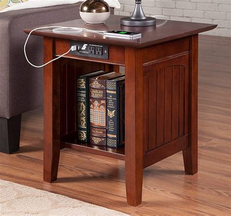 Whether used in a bedroom, living room, or office, the 24.25'' 1 Drawer End Table with Charging Station and Pull-Out Shelf combines style and functionality to enhance any interior setting. Exposed built-in charging station including 1 standard plug outlet & 2 USB ports; 1 drawer for concealed storage, 1 pull-out tray, smooth nickel drawer knobs .... End table with charging station
