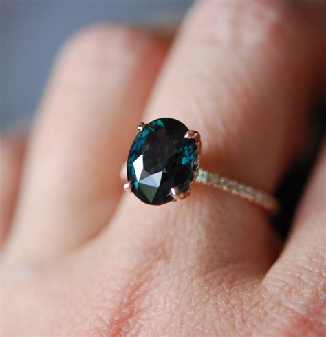 Engagement ring green sapphire. An oval cut green sapphire, encompassed by an organic linear band ... An oval cut green sapphire, encompassed ... ring was custom shaped to suit her engagement ring ... 