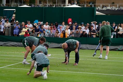 Environmental activists arrested at Wimbledon for throwing confetti and puzzle pieces on court