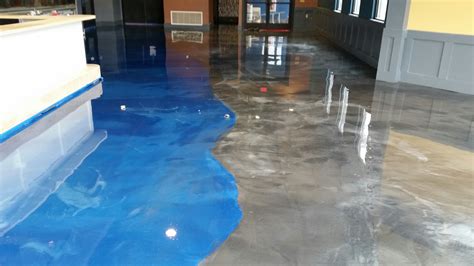 Epoxy concrete floor. Epoxy completely seals the concrete surface, whereas tile is adhered to the surface with a setting mud or adhesive. This adhesive does not stop moisture ... 