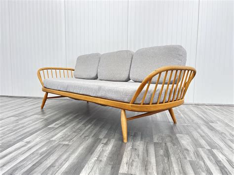 Ercol studio couch second hand.  The settee has a "surfboard" back and Shop our v...