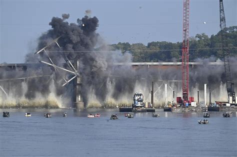 Explosives drop steel trestle Missouri River bridge into the water along I-70 while onlookers watch