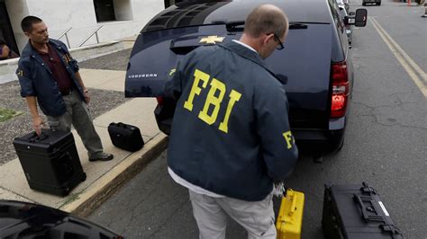 FBI raids home of ex-Maryland official as manhunt continues
