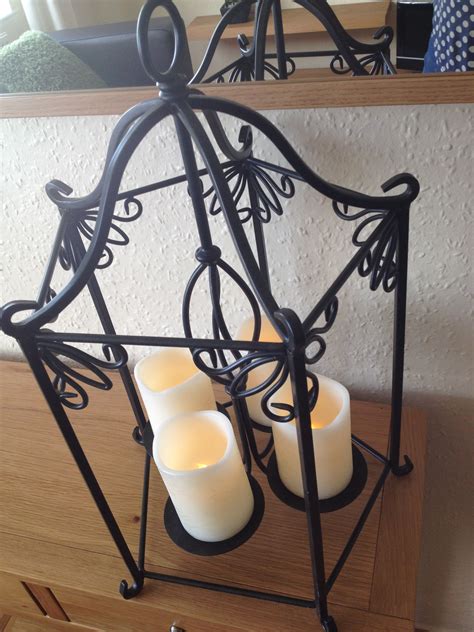 FOUR VANISHING CANDLES AND WROUGHT IRON …