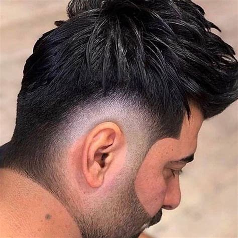 The Edgar cut with a high fade is popular and will suit people with strong hairlines. The hair is faded to the skin around the ears. The blend transition aligns well at the temples with the fringe. To wear your hair forward, first, dry it with some sea salt spray. Then, finish it off with a decent styling powder.. 