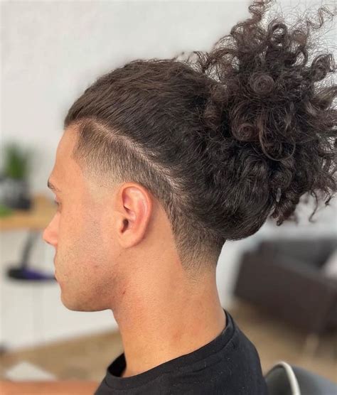Top Knot with Undercut and Mid Fade. This top-knot style is achieved by keeping the hair at the top of the head significantly longer. The sides are kept high and tight, and they are closely faded to the skin. Also, the front hair line is closely lined up for a more precise look. 3 / 27.. 