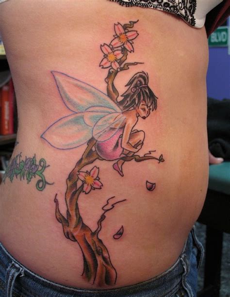 Fairy wings tattoo meaning. 5. Emo Angel Lower Back Tattoo. This falls into a category of angel tattoos that convey two messages at once. While the crouching figure of the girl is looking down conveying her frustration and despair the large angel wings sprouting out of her back give hope that she will one day fly again. 
