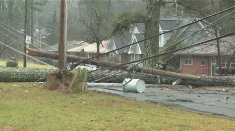 Falling tree takes down power line and damages cars in O'Fallon Illinois