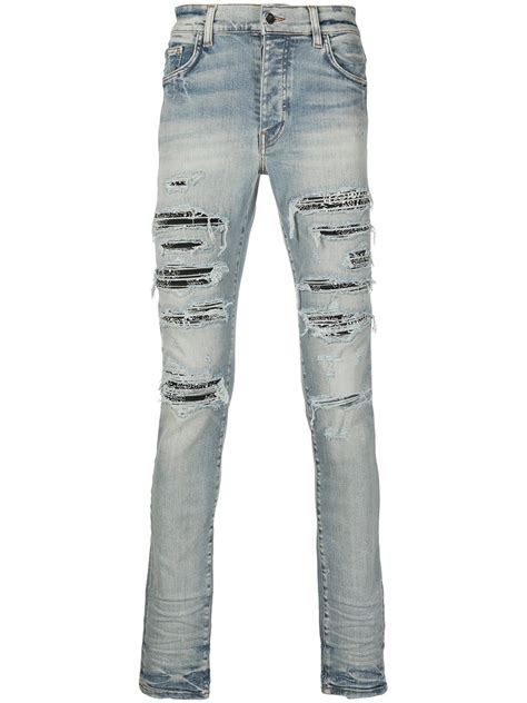 The Details. AMIRI. MX1 ripped skinny jeans. Known for its high-quality denim goods, Amiri presents these MX1 jeans in the SS23 collection. Made from faded light-blue denim, the classic skinny silhouette is adorned with ripped detailing and a logo patch to the rear. Made in United States.. 
