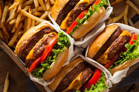 Fast food burgers. Fast food tends to be high in salt, sugar, saturated fats, trans fats, calories, and processed preservatives and ingredients. A wealth of well-conducted research has proven the negative health ... 