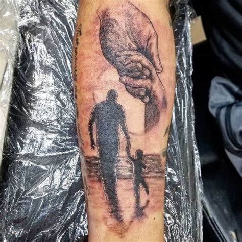 With its symbolic imagery and heartfelt message, this tattoo is a lasting tribute to a father who will forever be remembered as their first and greatest hero. Image: @blackdrip_art. 8. Grandad Loving Memory Tattoo Ideas. This sentimental tattoo features the word “Grandad” beautifully scripted with angel wings.. 