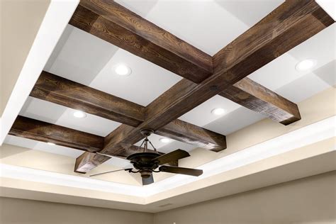 Faux wood beams for ceiling. Cut your pine boards to the desired length and width. Attach the boards together using screws or nails. distressed the boards by sanding them down or using a chemical stripper. Paint or stain the beams to the desired color. Install the beams by attaching them to the ceiling joists. 
