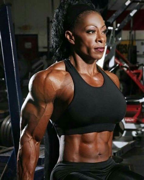 Delighted African American athletic female with strong arms