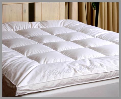 Feather mattress topper. Constructed by an ultra thick layer of soft duck down and feather, blended for a supremely comfortable sleeping experience. Cover: 100% cotton. Filling: 85% white duck down 100gsm + 5% white duck 1600gsm. Care instructions: fluff and air prior to use and at regular intervals. dry clean only. protect from direct sunlight. 