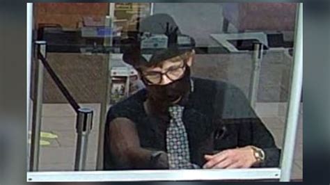 Fedora and wig-wearing bank robber on the run after …