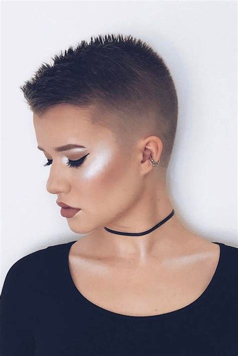 Fluffy Razored Brunette Pixie. The spiky top and side-swept baby bangs give an urban, modern feel to short pixie haircuts. Match your dark brown hair color to your eyebrows to enhance the chic and dramatic flair of your look. The long, angular sideburns are delicate and feminine.. 
