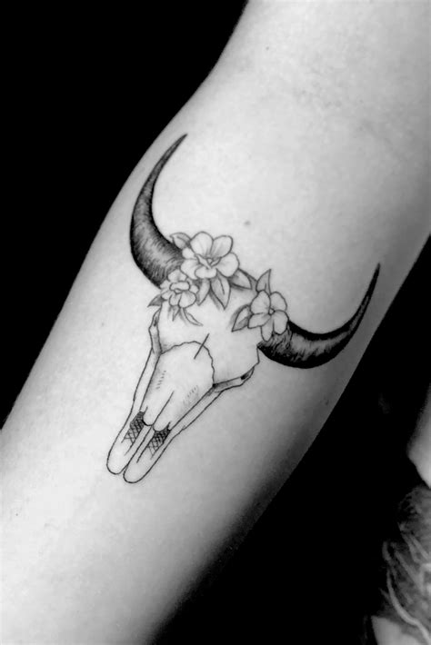 Feminine cow skull tattoo. Strength: This is an obvious meaning for the tattoo as bulls are often seen as symbols of power and strength. Bulls can be very aggressive creatures who can work with sheer power and strength. So the bull skull tattoo is also given these meanings. Determination and resolve: Bulls are very deterministic creatures. 