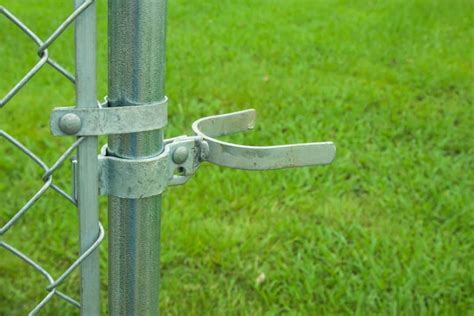 Fence gate latch.  The latch fits over the terminal post and attaches to ...