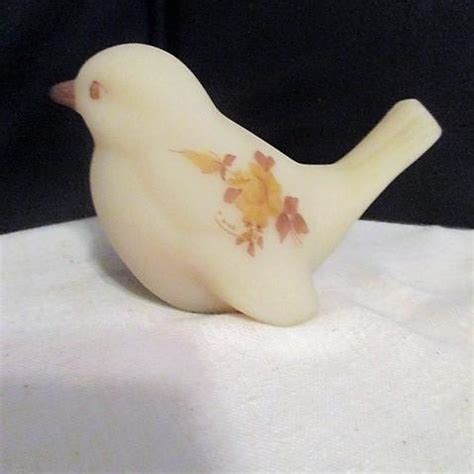 Fenton Custard Green Bird of Happiness Figurine. This item is a seagreen frosted glass and has hand-painted flowers in relief on both sides of the bird and up the tail from one side. The blossoms on it are pink and white (like appleblossoms) and those flowers as well as the pink beak are "dew drop" effect (sparkly).. 