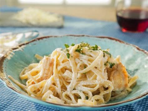 Bring a large pot of lightly salted water to a boil. Cook fettuccine in boiling water, stirring occasionally, until nearly cooked through, about 7 minutes. Drain. Stir parsley, 1 cup of Parmigiano-Reggiano, and cream mixture into the pasta. Remove from heat, cover, and let sit for a few minutes until thick.. 