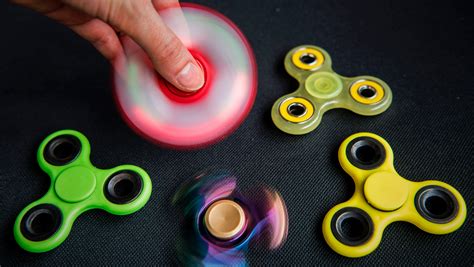 Fidget spinner. Fidget Spinners. Fidget spinners, usually made from plastic or metal, are a three-pronged tool that fits in your hand and is meant to be spun. These can be helpful for people who struggle with ... 