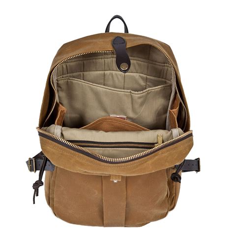 Filson journeyman backpack. Look like the worldly traveler you are with the Filson Journeyman Backpack in Tan - subtly stowing your business laptop. The rectangular design provides maximum storage space, while the fully padded interior offers ample protection. A shoulder strap adds carry convenience, pockets for a pen and a cellphone are provided, and grommets in the ... 