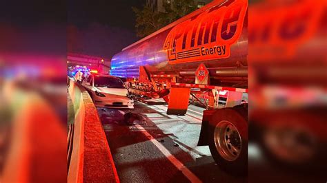 Fire crews rescue driver pinned between tanker truck, barrier in Boston