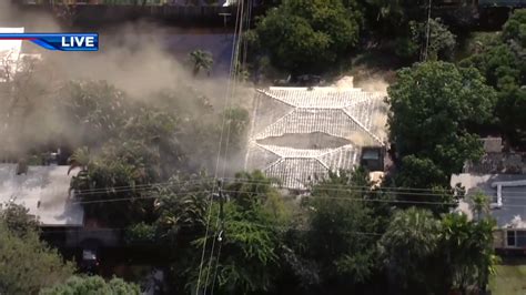 Fire crews work to put out house fire in Fort Lauderdale as flooded roadways makes travel difficult