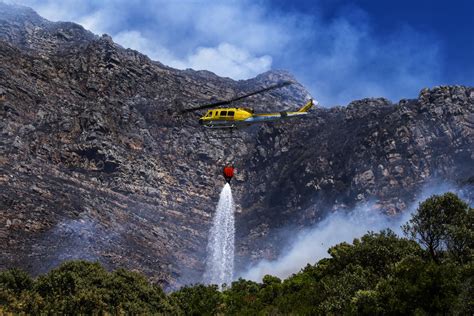 Firefighters battle a wildfire on the slopes of a mountain near Cape Town in South Africa