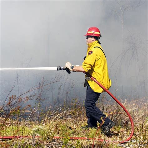 Firefighters battle cross-border brush fire