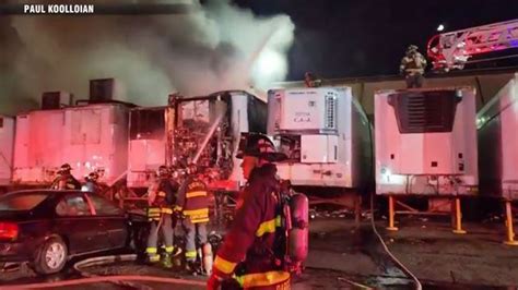 Firefighters battle flames after trailers ignite at New England Produce Center in Everett