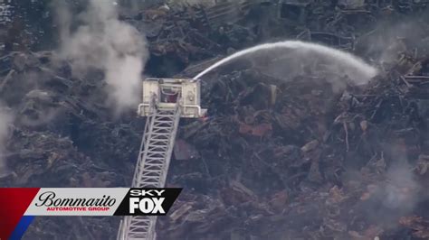 Firefighters battle huge blaze at salvage yard, extreme temperatures