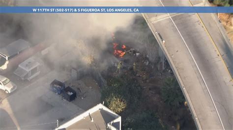 Firefighters extinguish another fire underneath another Los Angeles freeway