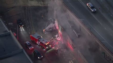 Firefighters put out garbage fire next to 10 Freeway in downtown Los Angeles