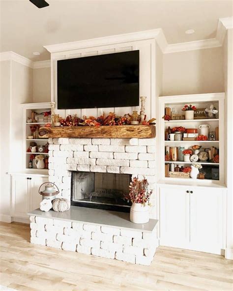 Fireplace with built ins on each side. a whitewashed brick fireplace with a brick mantel, a round mirror, a metal frame and a candle lantern is stylish. a whitewashed brick fireplace with a wooden mantel, rustic decor and potted greenery is rustic and cozy. a whitewashed faux stone fireplace with a small mantel and an artwork adds warmth and … 