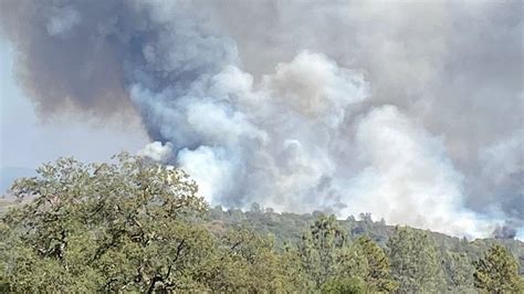 A 4.2-square-mile wildfire pushed by gusty winds from a thunderstorm raced through national forest land near California's border with Oregon, prompting evacuations in the rural area.