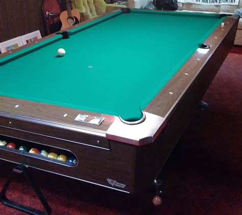 Perfect for a man cave, bar, or garage. Maybe put it in your yard and make it a conversation piece. Been indoors up into yesterday. Now it's in the garage. The legs DO come off, was able to move the table vertically on casters, so you should be able to too for moving in tight spaces. Comes with balls and 3 cues. 7' table. Everything works as it .... 