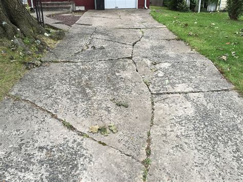 Fix concrete driveway. Depending on how large these cracks are, you might be able to fill them with Timbermate 500g Concremate Expanding Cement and paint the areas to conceal the repairs. Alternatively, embedding the same aggregate used in the rest of the driveway into the surface of the cement filler will be needed for larger cracks. 