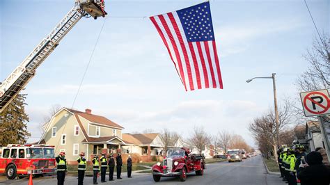 Flags fly during procession for fallen Hermann officer