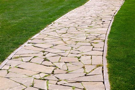 Flagstone path. Sandstone flagstone is ideal for use indoors and with underfloor heating; they can also be laid outside for patios, seating areas, and garden paths. The color of sandstone flagstone varies depending on its mineral composition and ranges from beige to red. Blue -gray and lilac-gray are common sandstone colors as well. 