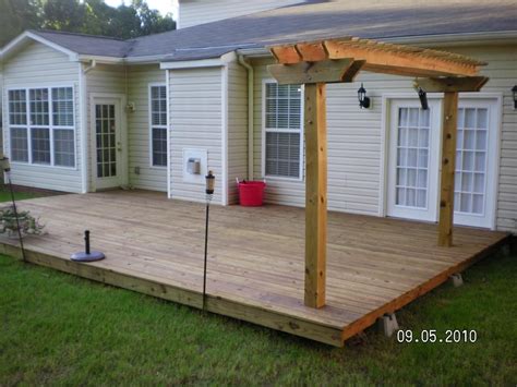 Floating deck with pergola. Locate the line 2-3/4 in. from the post’s on-center point. Fit the post notch over the joist and align the post to the line you just drew. Plumb the post and drill through the holes in the post into the joist. 2. Brace the corner post. Use 2x4s to brace the corner post or posts against the deck rim joists. 