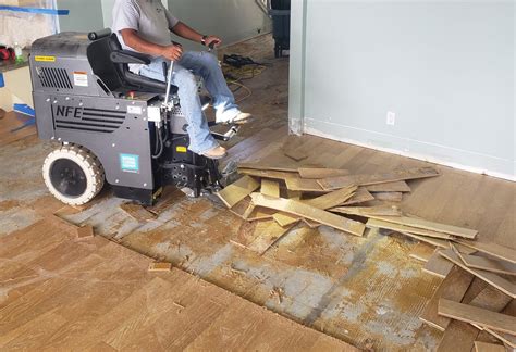 Floor removal. STEP 2: Cut into 12-inch strips. Next, locate a section of the floor with no glue underneath. Start removing vinyl flooring right here, using a utility knife to cut the material into 12-inch ... 