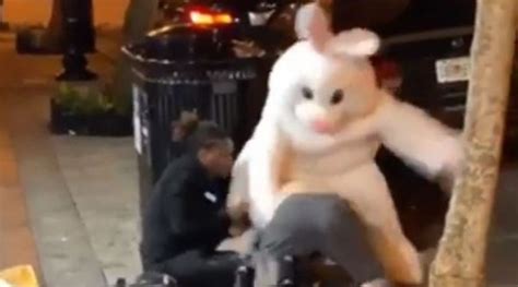 A person wearing a full-body Easter bunny costume hopped to t