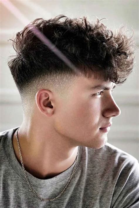 The fluffy broccoli with a low fade is a fresh haircut that combines a textured top with crisp, clean lines. The low fade draws focus to the bushy top, while the sleek shape up brings structure to the front and sides with razor-sharp angles. A chin goatee is the masculine finishing touch that brings balance and cohesion to this approach.