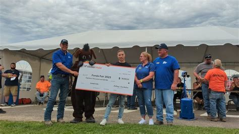 Fonda Fair presented with $18,000 check from Sticker Mule