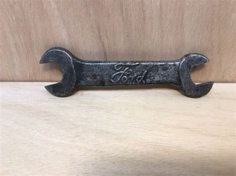 This antique Ford 1 and 2 Script Open End Wrench T-1917 is a perfect addition to any collector's toolbox. Made in the United States with high-quality materials, this tool is a rare find for those who appreciate vintage mechanics. The wrench is branded with the Ford name, adding to its historical value. Ideal for those interested in collectibles ...